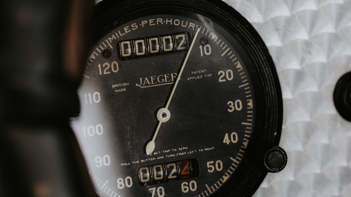 A close-up view of a classic Jaeger speedometer, showcasing vintage automotive design.